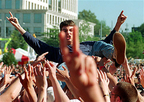 A teenager slams (a crowdsurfer) at a rock concert - © Quibic/Flickr/Wikipedia